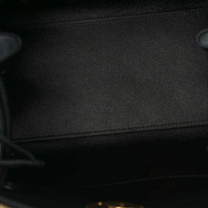Black fabric lining inside a small leather handbag