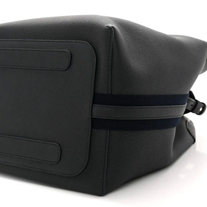 Dark navy leather flap panel with seam details and adjustable crossbody strap