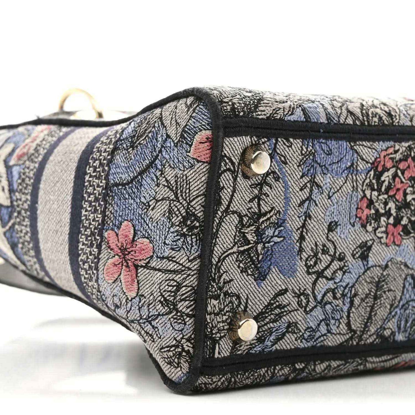 Christian Dior embroidered denim bag side with snap closure and metal rivets