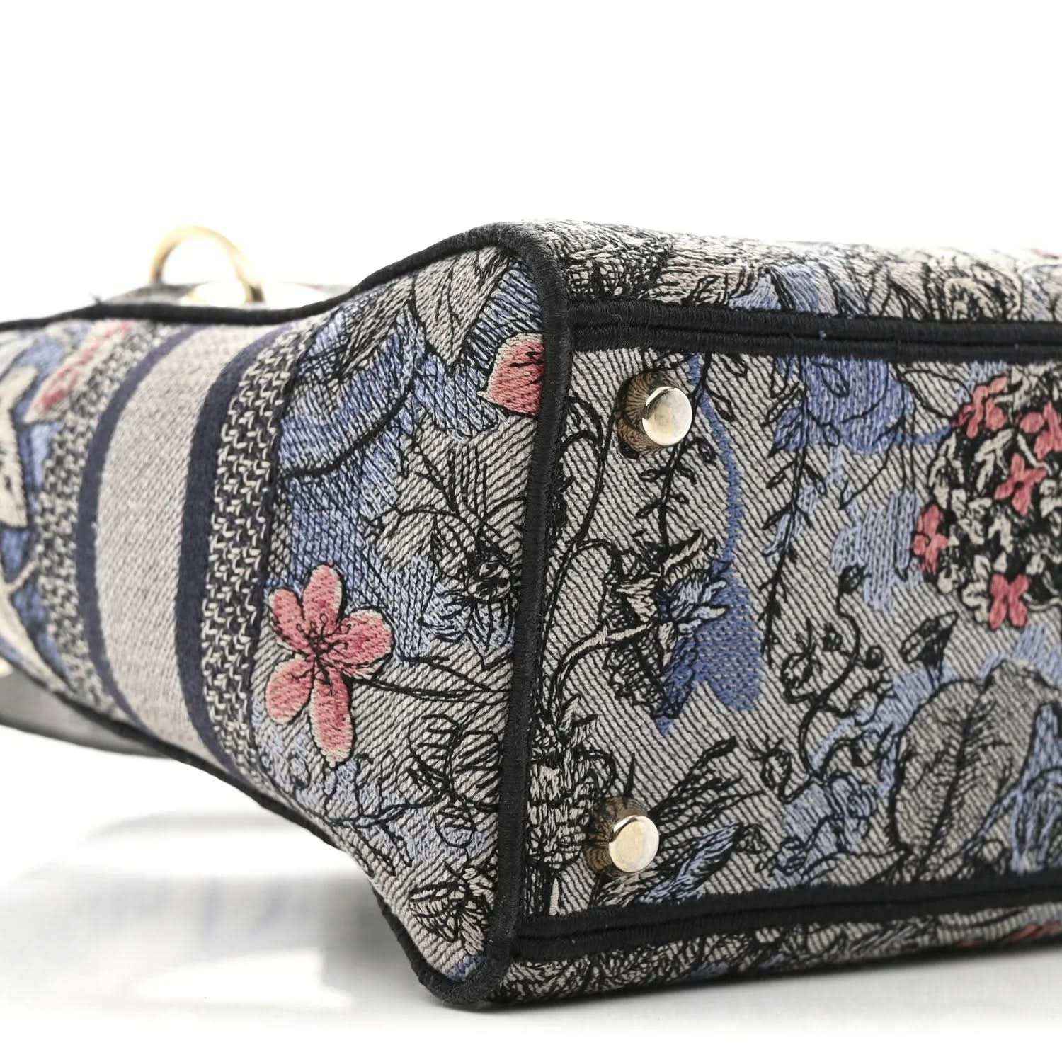 Christian Dior embroidered denim bag side with snap closure and metal rivets