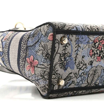 Christian Dior embroidered denim bag side with snap closure and metal rivets