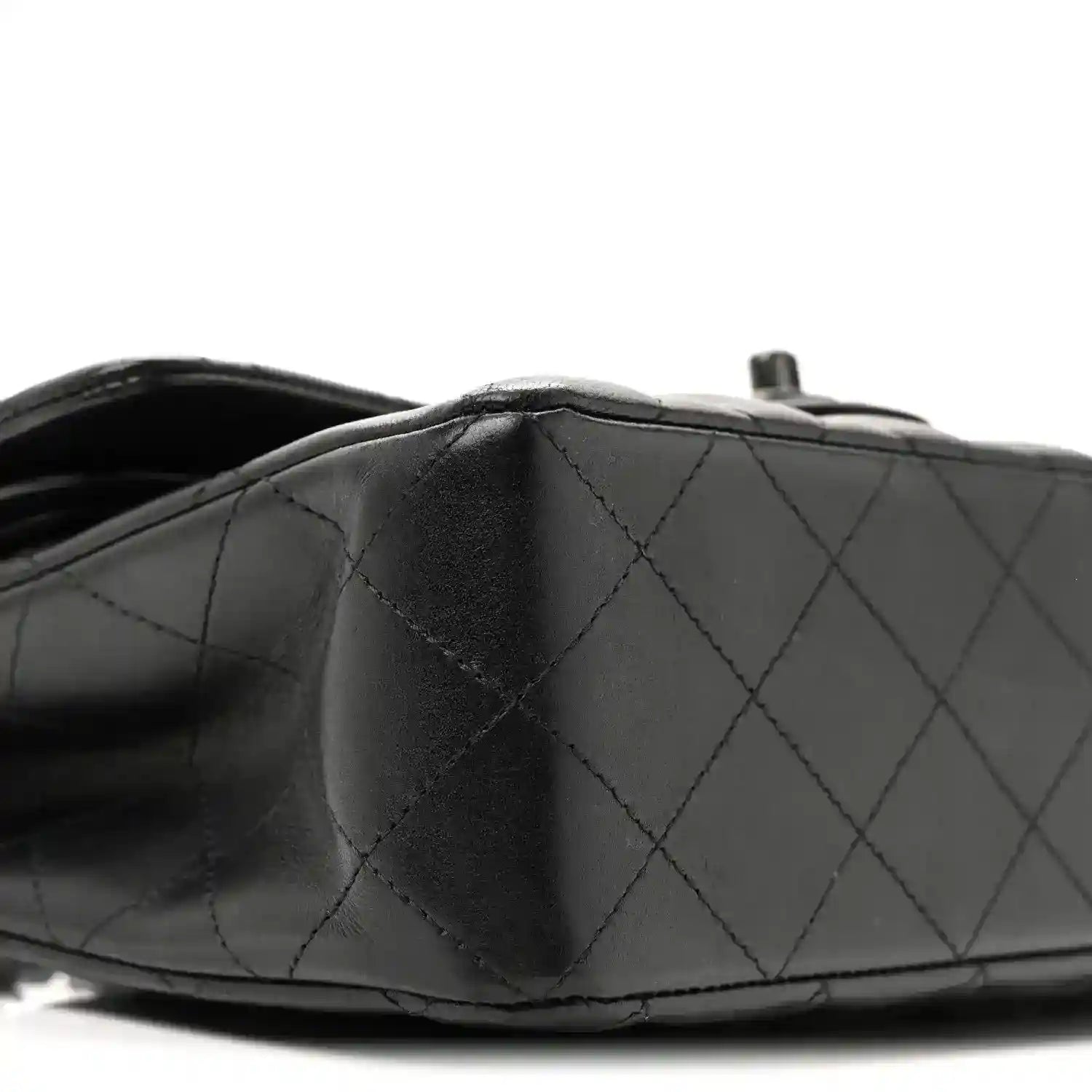 Chanel quilted lambskin double flap bag in dark black with diamond stitching near the top