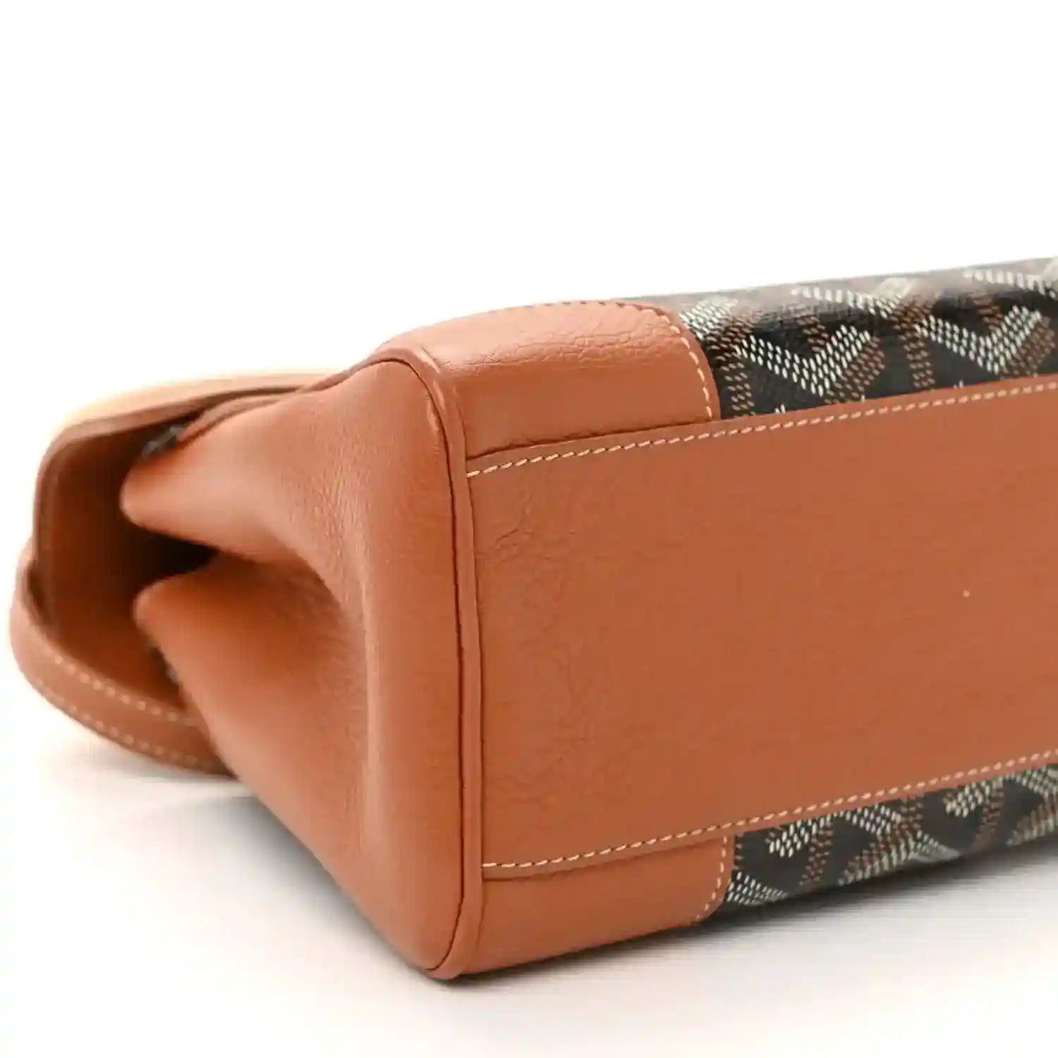Mini Saigon bag bottom corner close-up, brown leather with patterned canvas trim