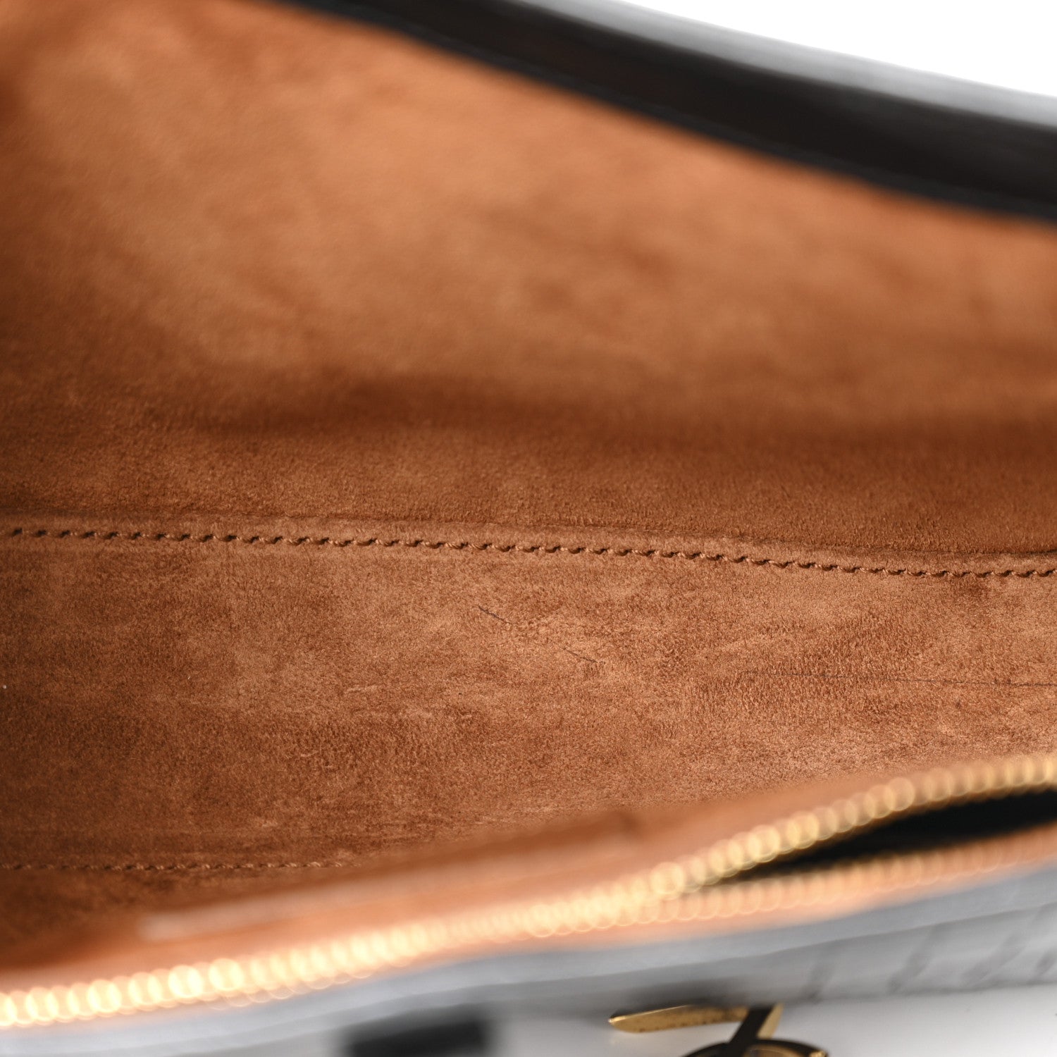 Close-up of hobo bag interior seam and tan lining.