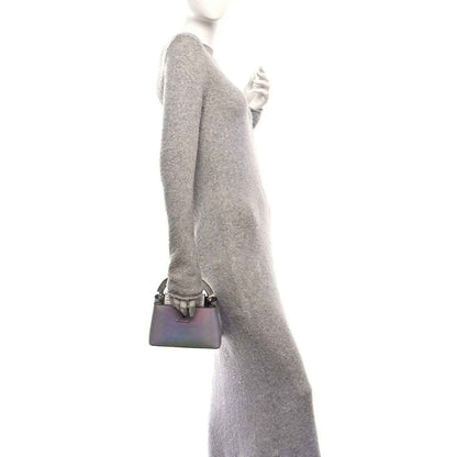 Iridescent lizard mini handbag with short top handle, worn at side