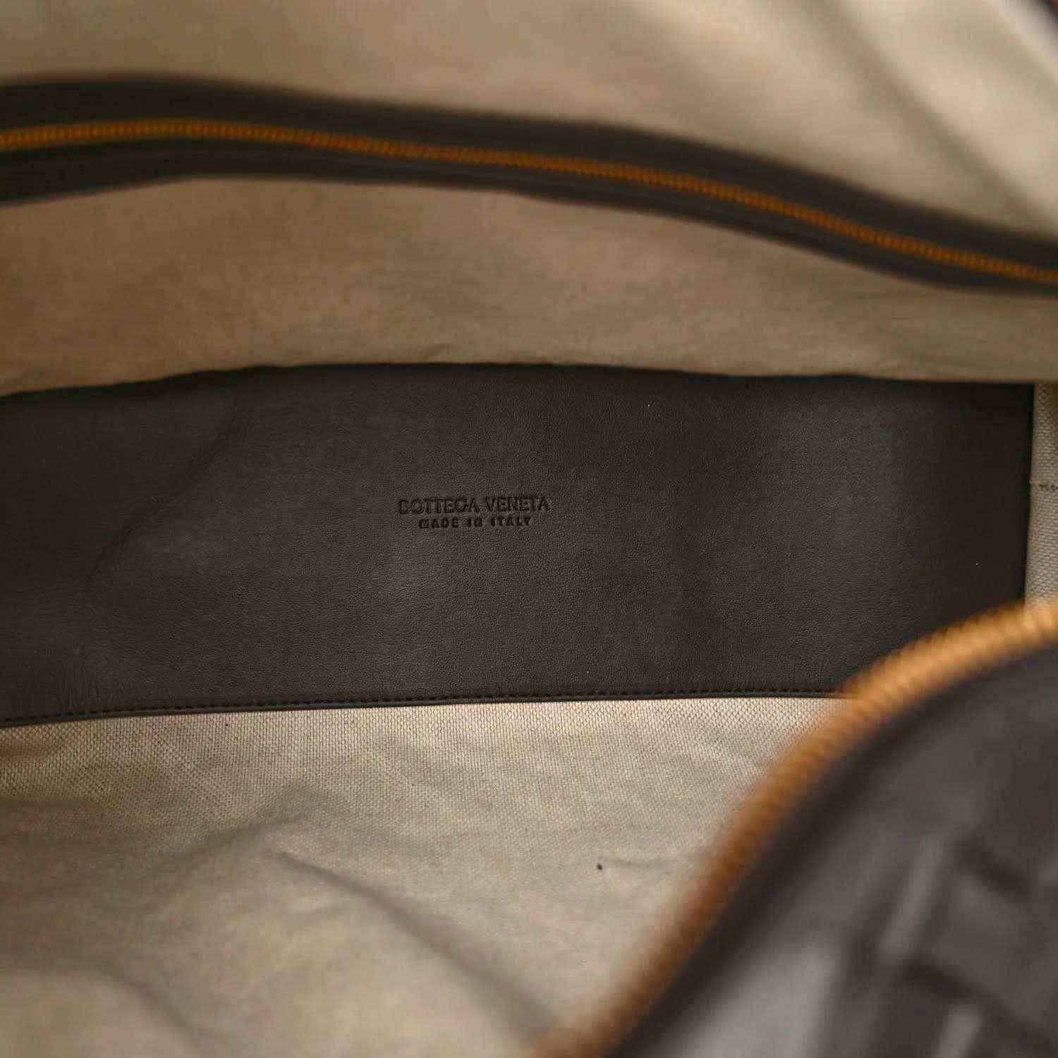 Black leather weekender bag interior lining with Bottega Veneta logo stamp