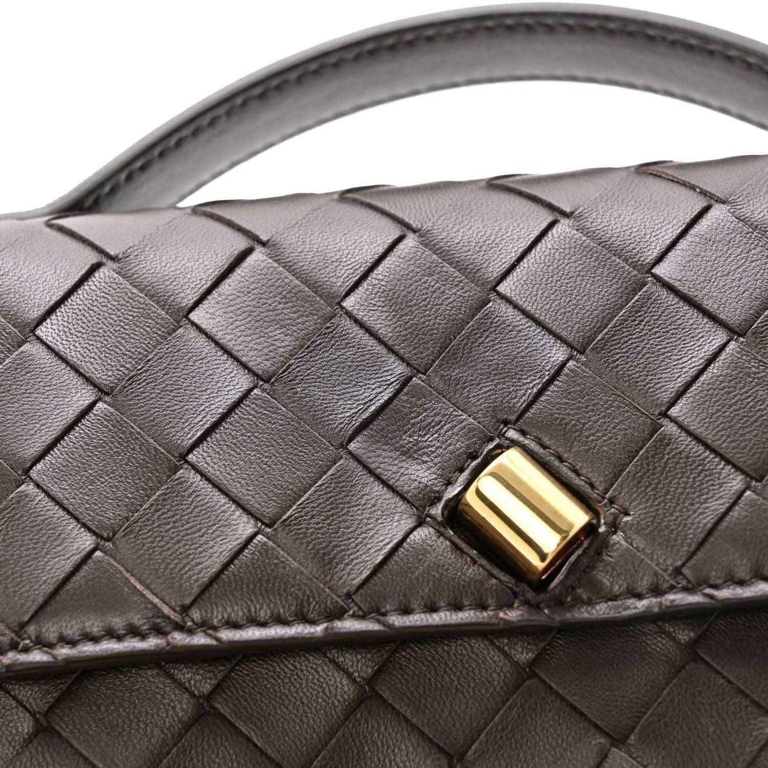 Interlaced nappa leather clutch with gold-tone clasp detail and top handle strap