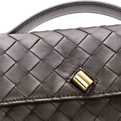 Interlaced nappa leather clutch with gold-tone clasp detail and top handle strap