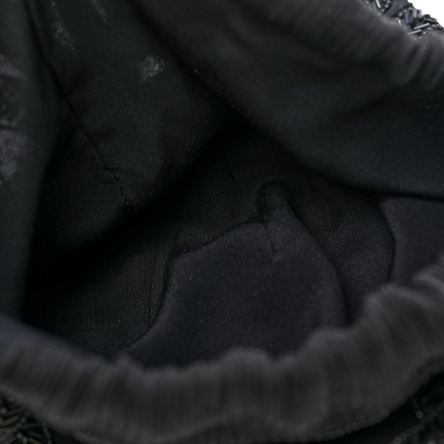 Black fabric lining of the chiffon silk crepe pochon bag with pleated edge