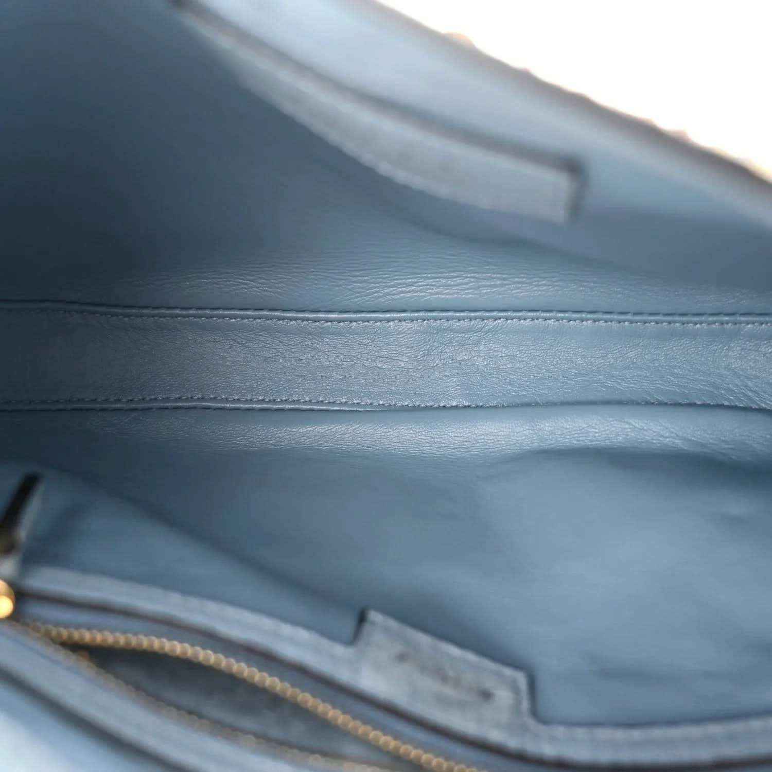 Hobo bag interior with light blue lining and zipper pocket detail