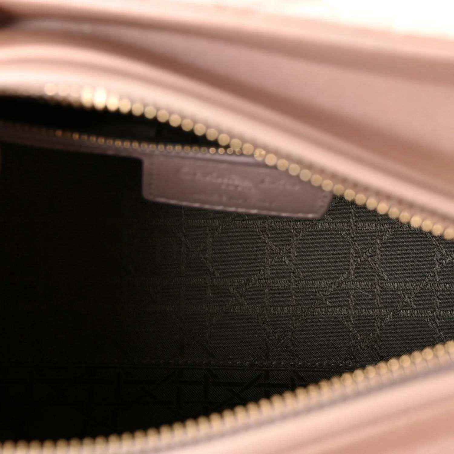 Handbag interior lining with monogram pattern and gold-tone zipper trim