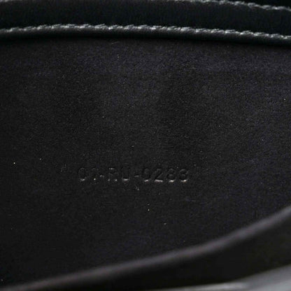Embossed serial number on black interior panel of quilted handbag