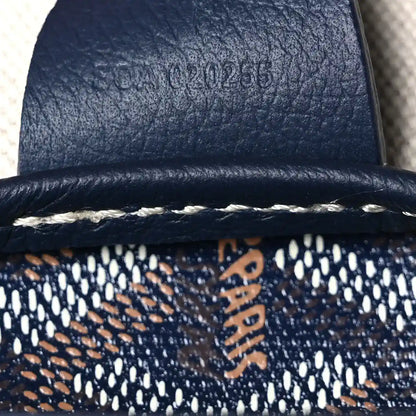 Goyardine tote bag strap end with smooth navy trim and woven logo canvas
