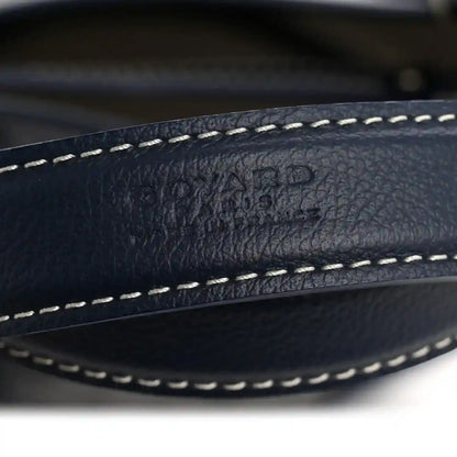 Navy leather trim with white contrast stitching along the edge