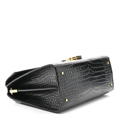 Black crocodile-embossed medium top handle bag with gold feet and side flap
