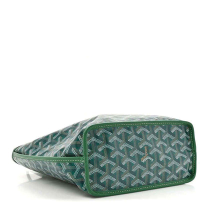 Green patterned reversible tote bag laid on its side with top handles and logo patch