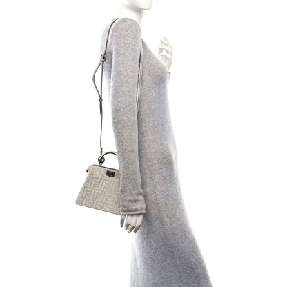 Crystal-embellished mini satchel with short top handles and crossbody strap, silver tone.