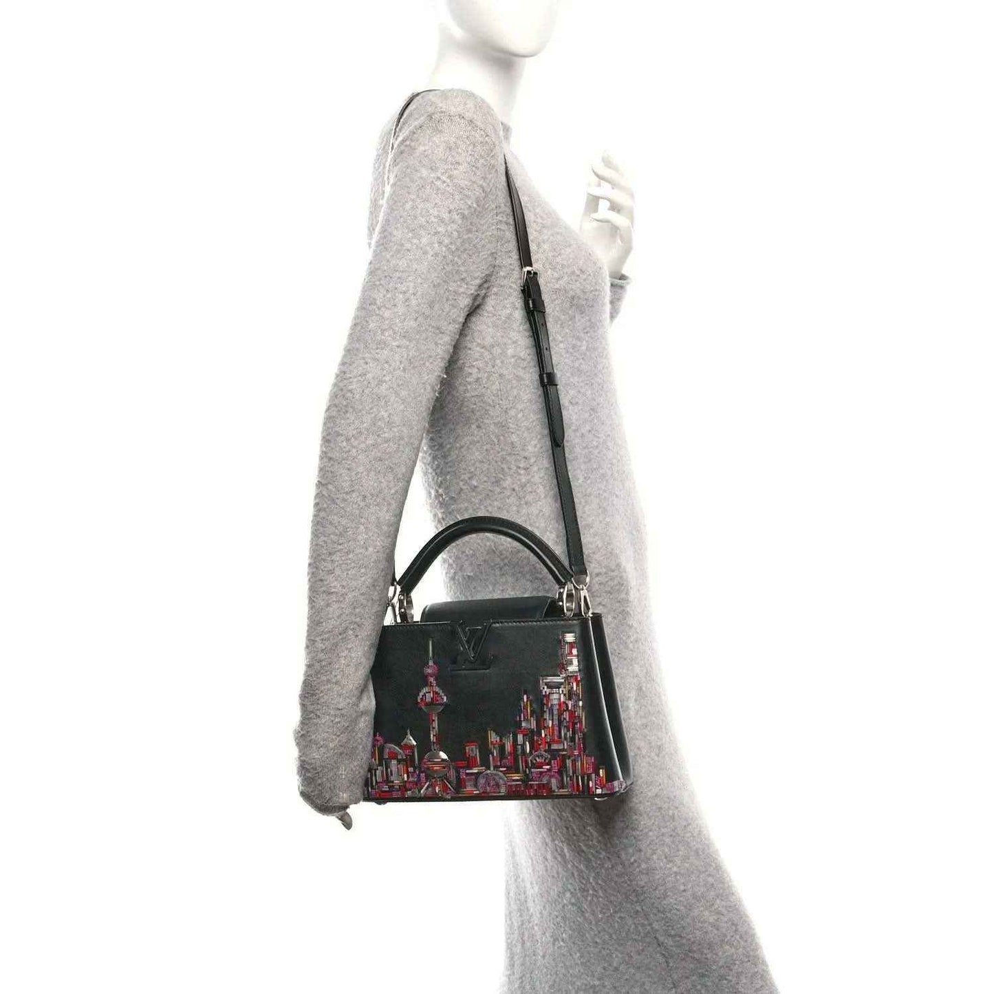 Capucines BB black beaded skyline bag worn on shoulder with long strap
