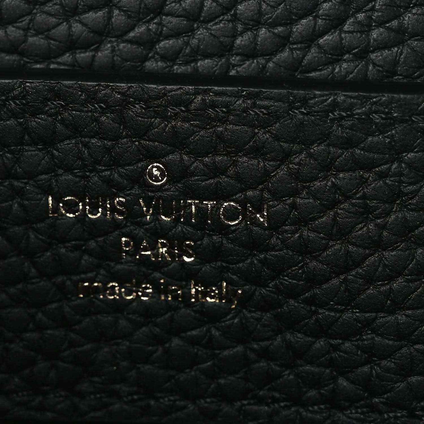 Louis Vuitton Paris embossed on black leather handbag panel