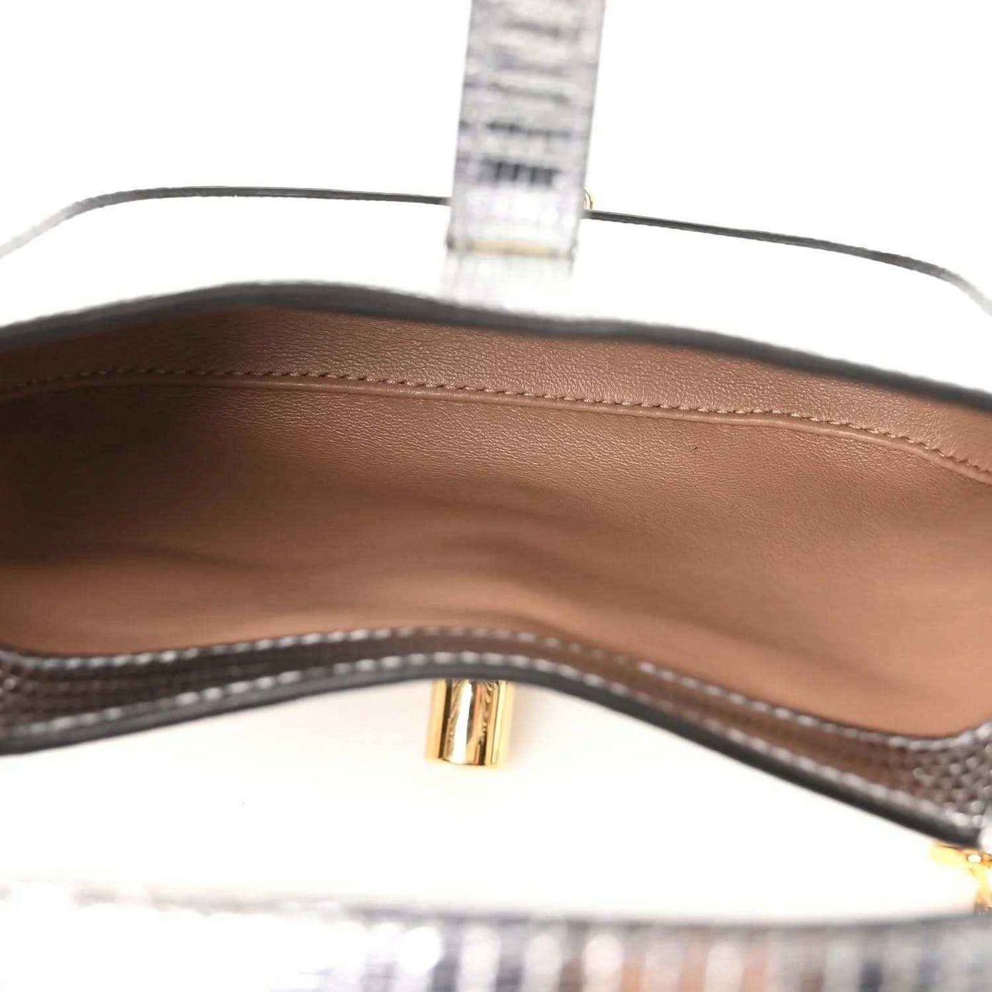 Brown leather-lined interior of silver mini shoulder bag with gold-toned hardware
