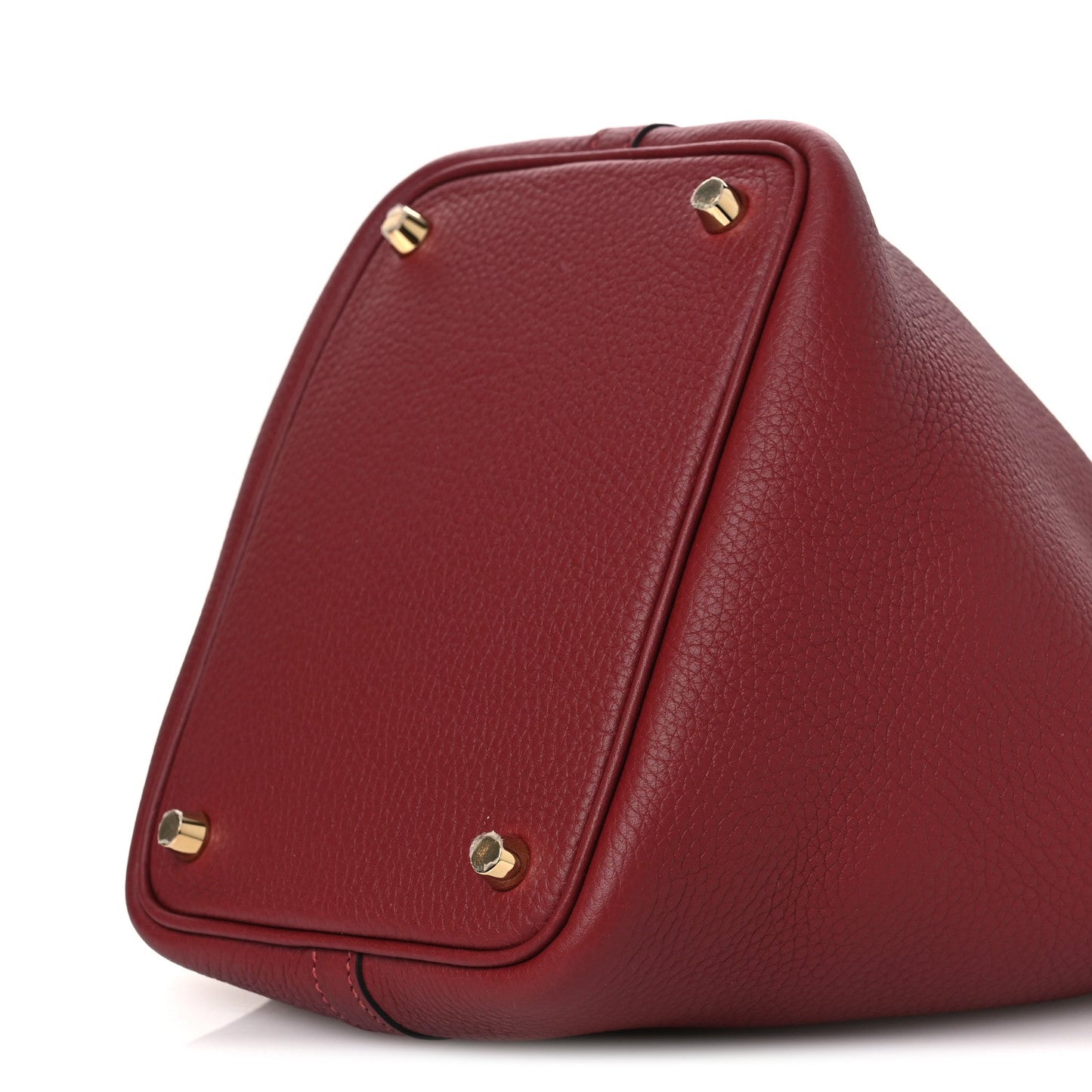 Burgundy grained leather tote with gold-tone corner hardware on flap