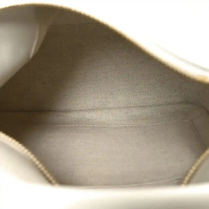 Small Puzzle edge bag interior view with fabric lining and stitched inner seams