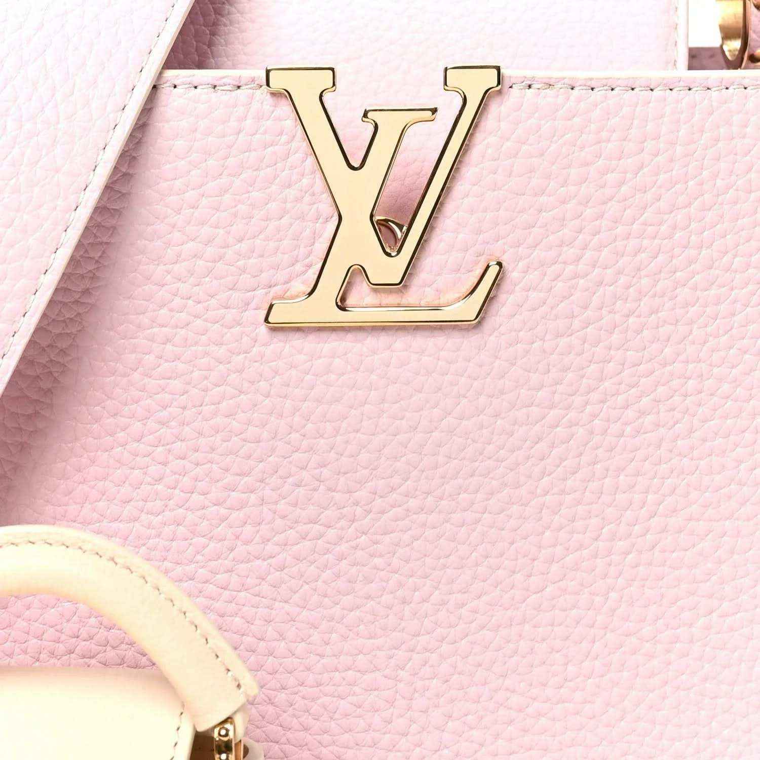Pink leather handbag with gold LV front emblem and textured grain