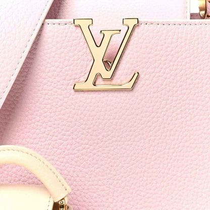 Pink leather handbag with gold LV front emblem and textured grain