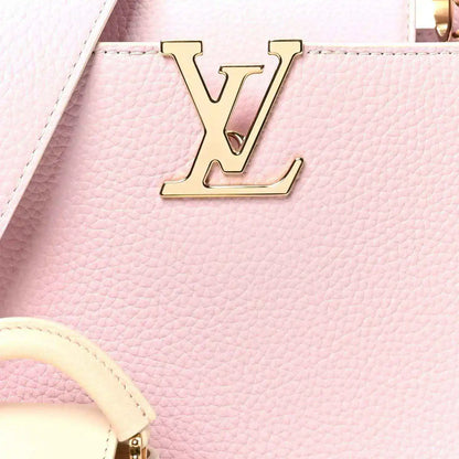 Pink leather handbag with gold LV front emblem and textured grain