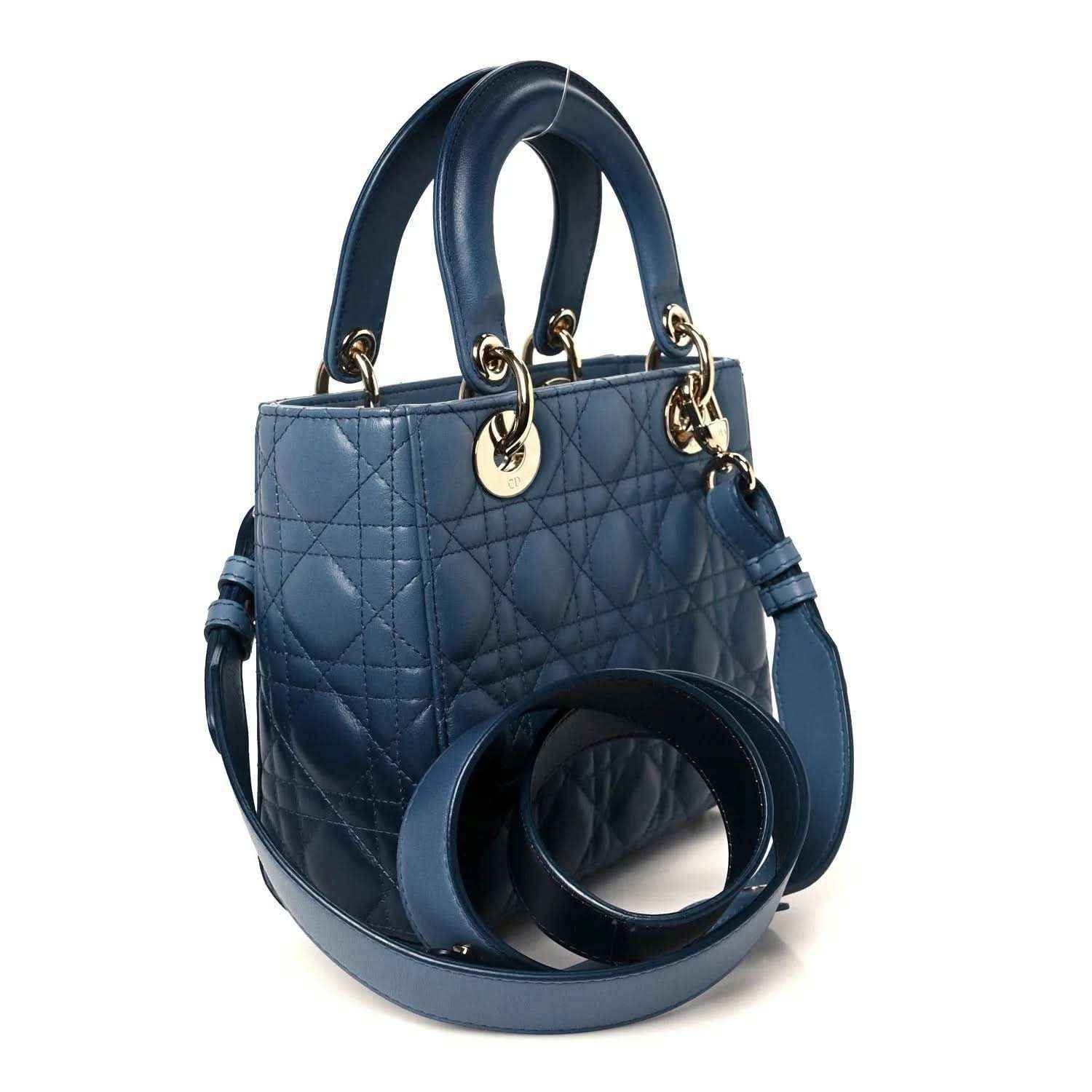 Small quilted indigo blue leather handbag with loop handles and side strap