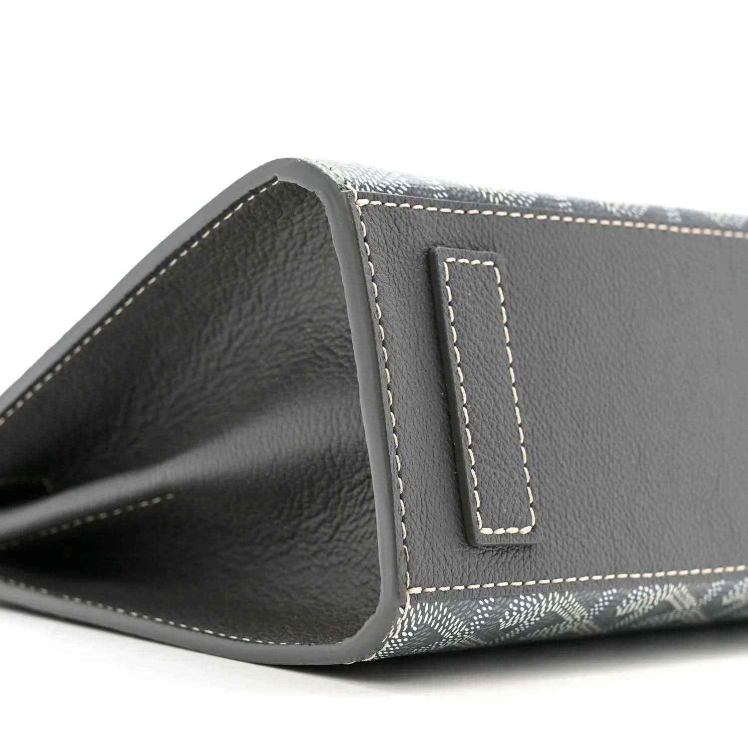 Grey shoulder bag interior opening with black leather trim and stitched tab detail