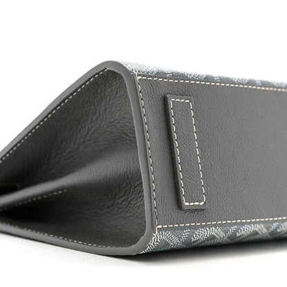 Grey shoulder bag interior opening with black leather trim and stitched tab detail