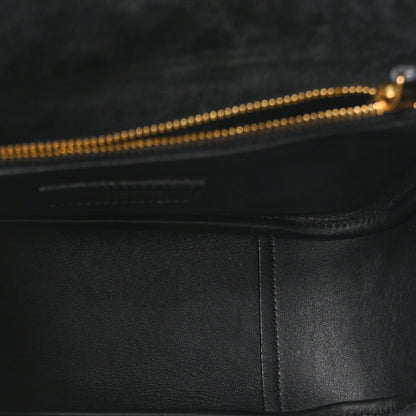 Black leather hobo bag interior edge with gold-toned zipper pull detail