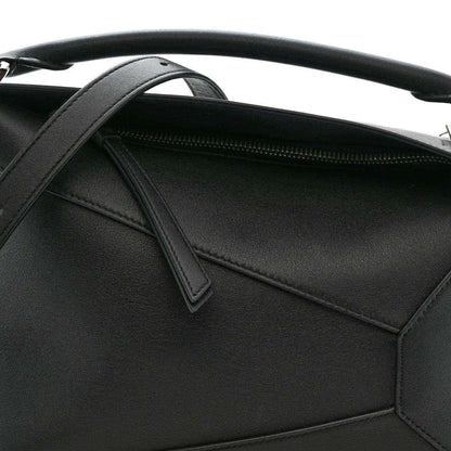 Small Puzzle Edge shoulder bag interior view with black leather pocket and zipper