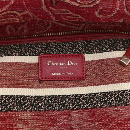 Red handbag label patch reading “Christian Dior Paris” and “Made in Italy”