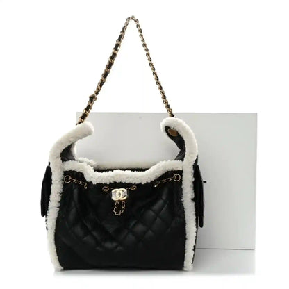 Chanel quilted handbag with shearling trim, black exterior and white interior, chain handle