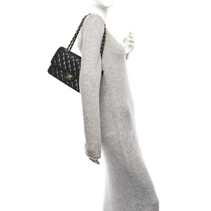 Chanel medium double flap bag with gold chain strap, black quilted leather profile