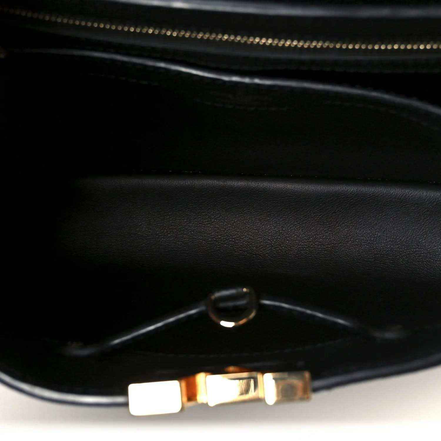 Black leather handbag interior with zipper and metal pull