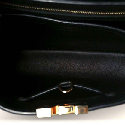Black leather handbag interior with zipper and metal pull