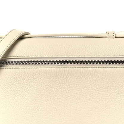 White grained calfskin pouch zip track and handle loop, close-up