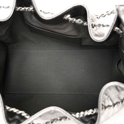 Chanel handbag interior close-up with black lining and silver chain strap