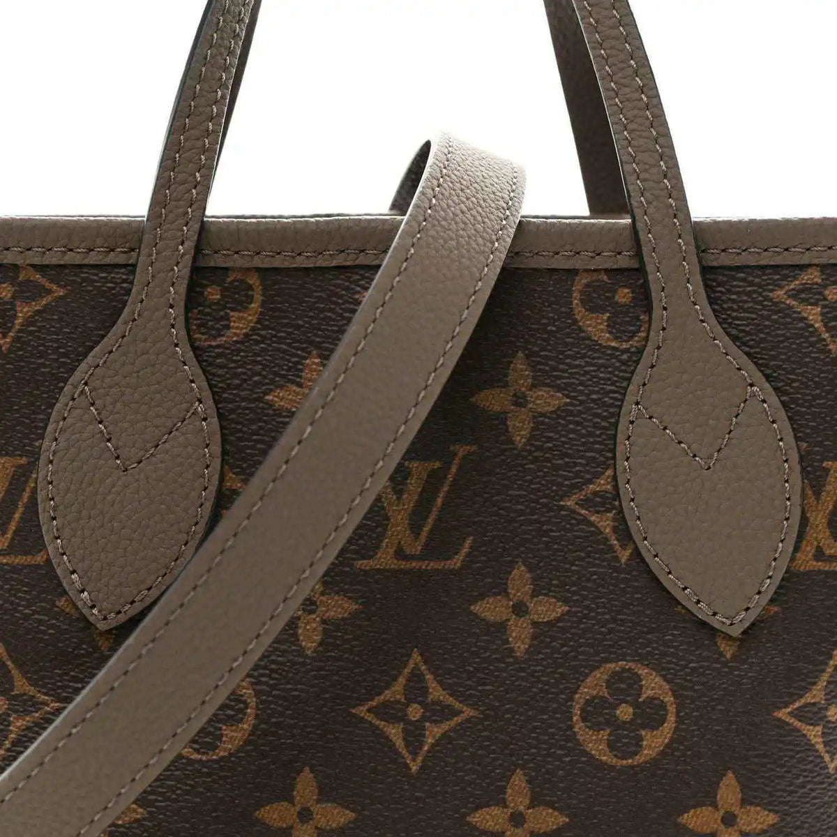Dark monogram tote with gray leather handles and arched opening strap detail