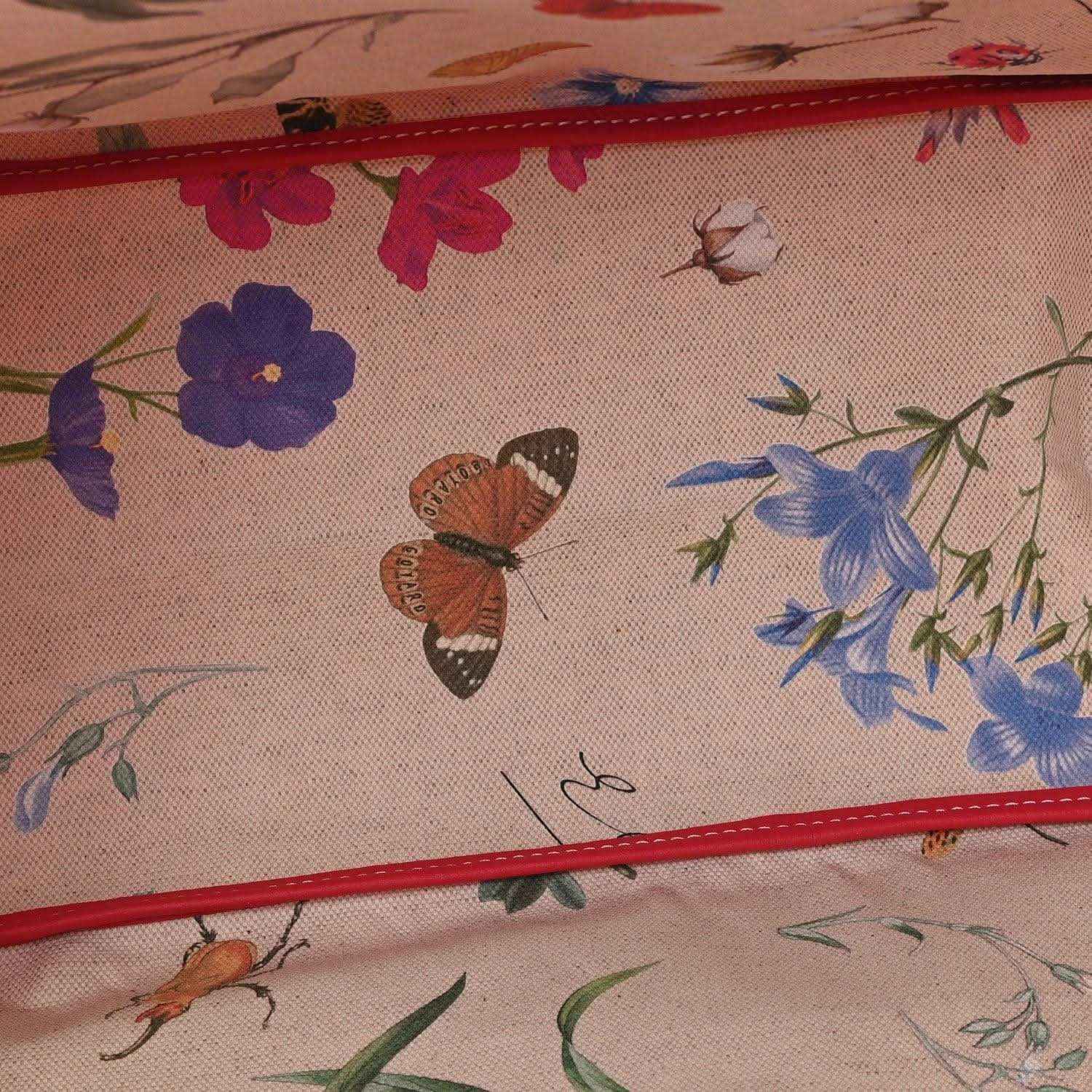 Floral-lined interior of a fuchsia tote bag with butterflies and blooming flowers