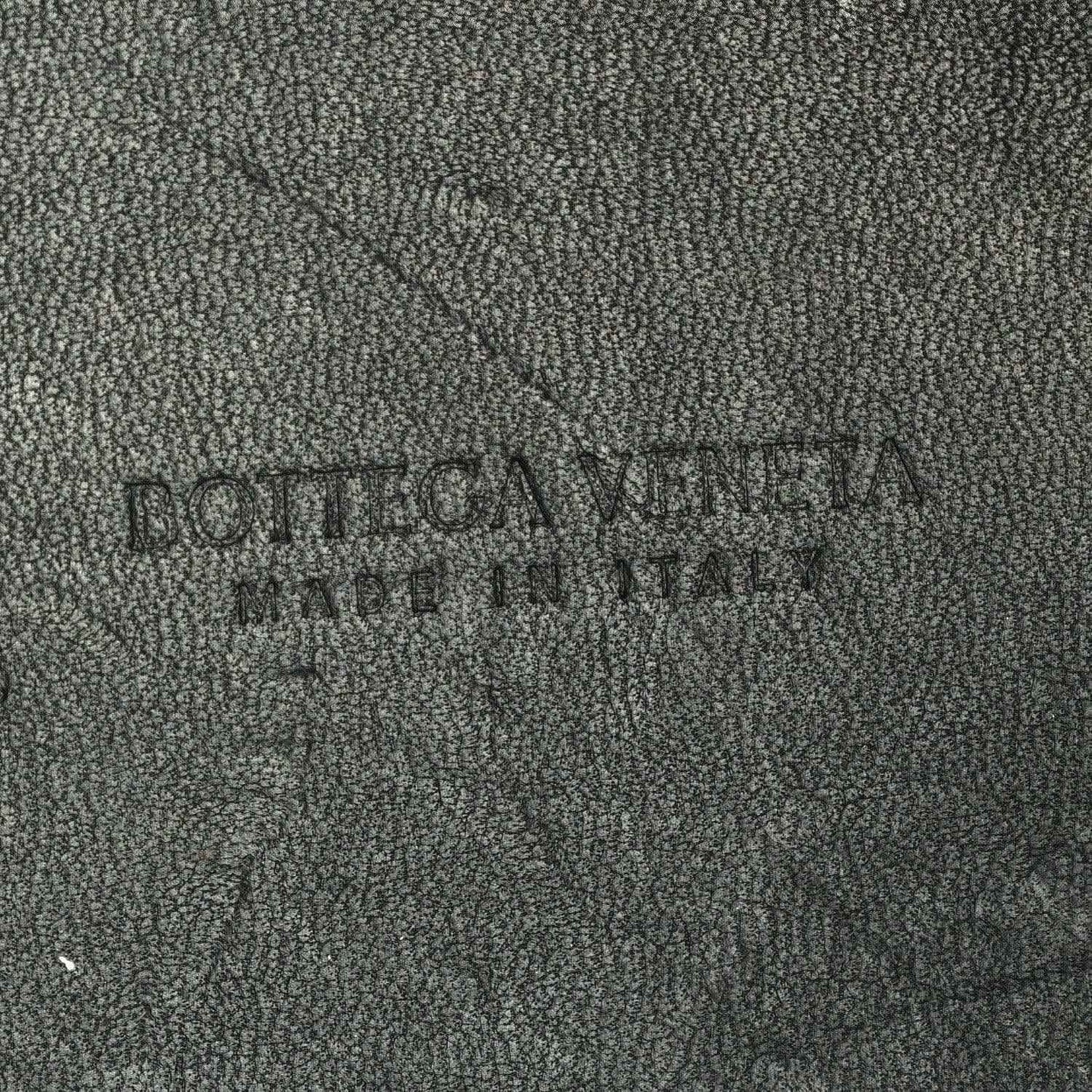 Black leather interior panel with embossed brand name