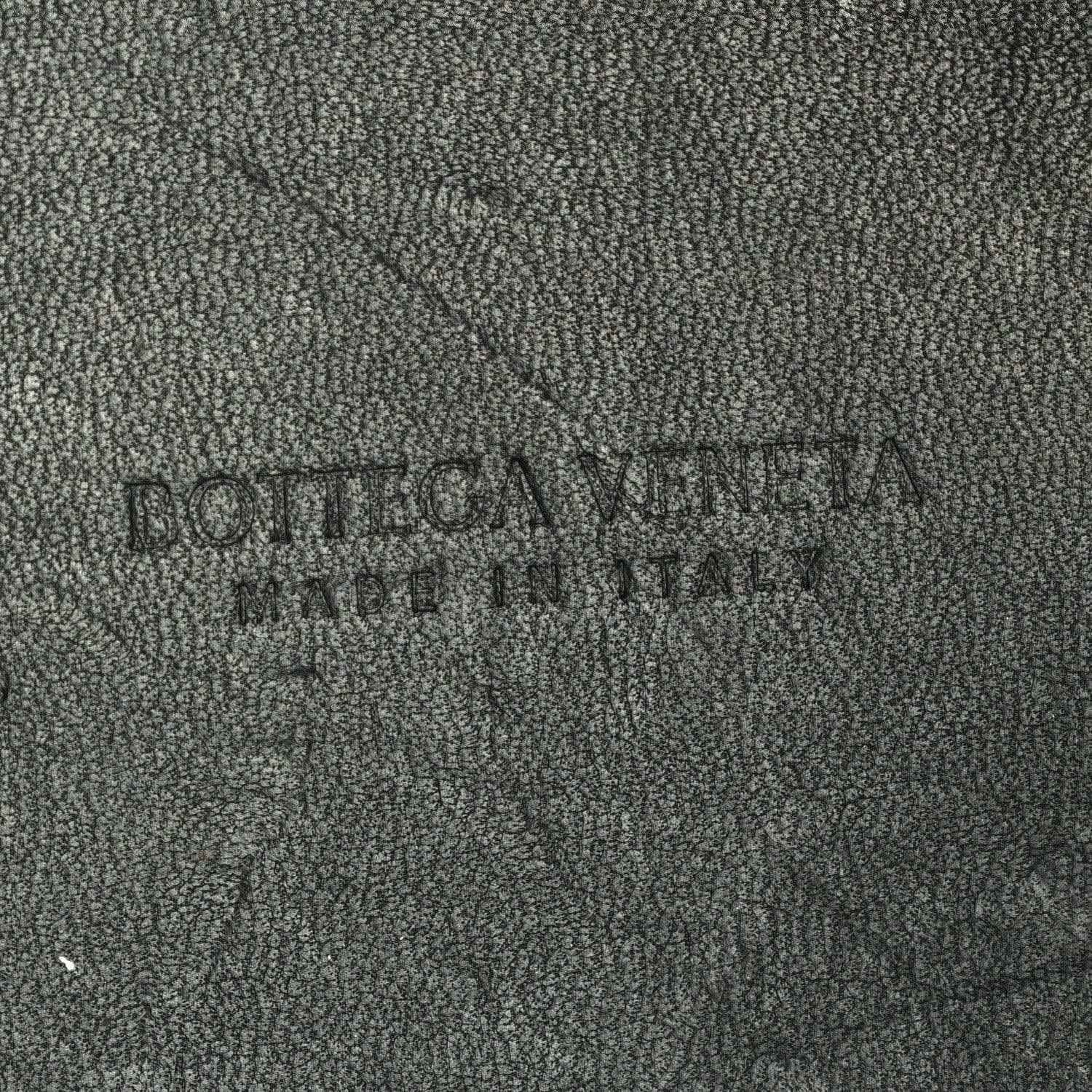 Black leather interior panel with embossed brand name