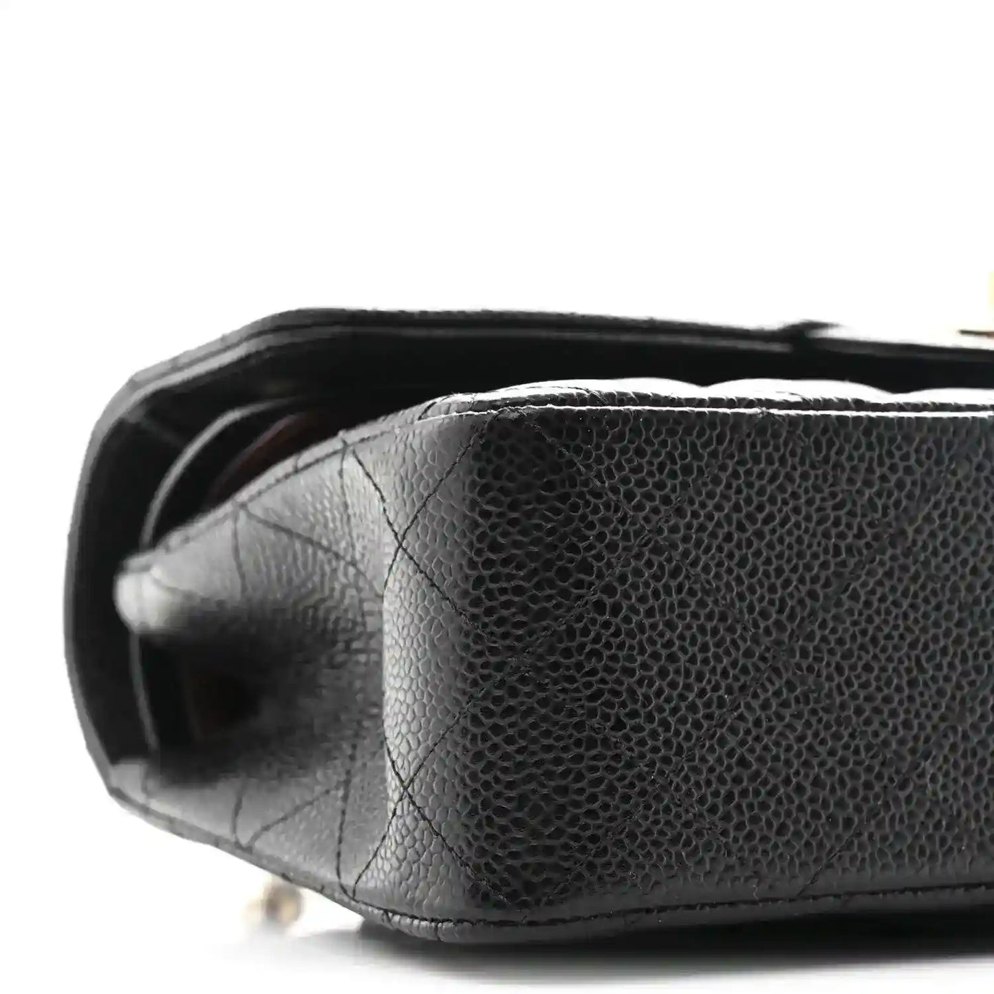 Chanel small double flap bag bottom view, black pebbled leather texture and curved edge