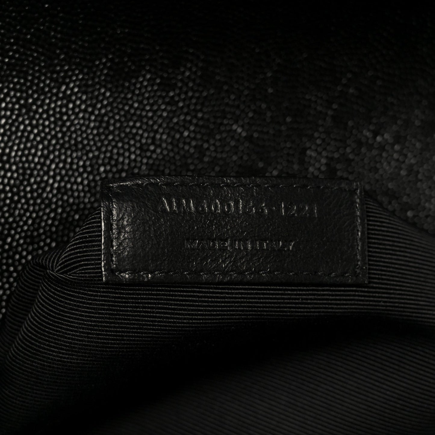 Black interior tag label with embossed text on lining