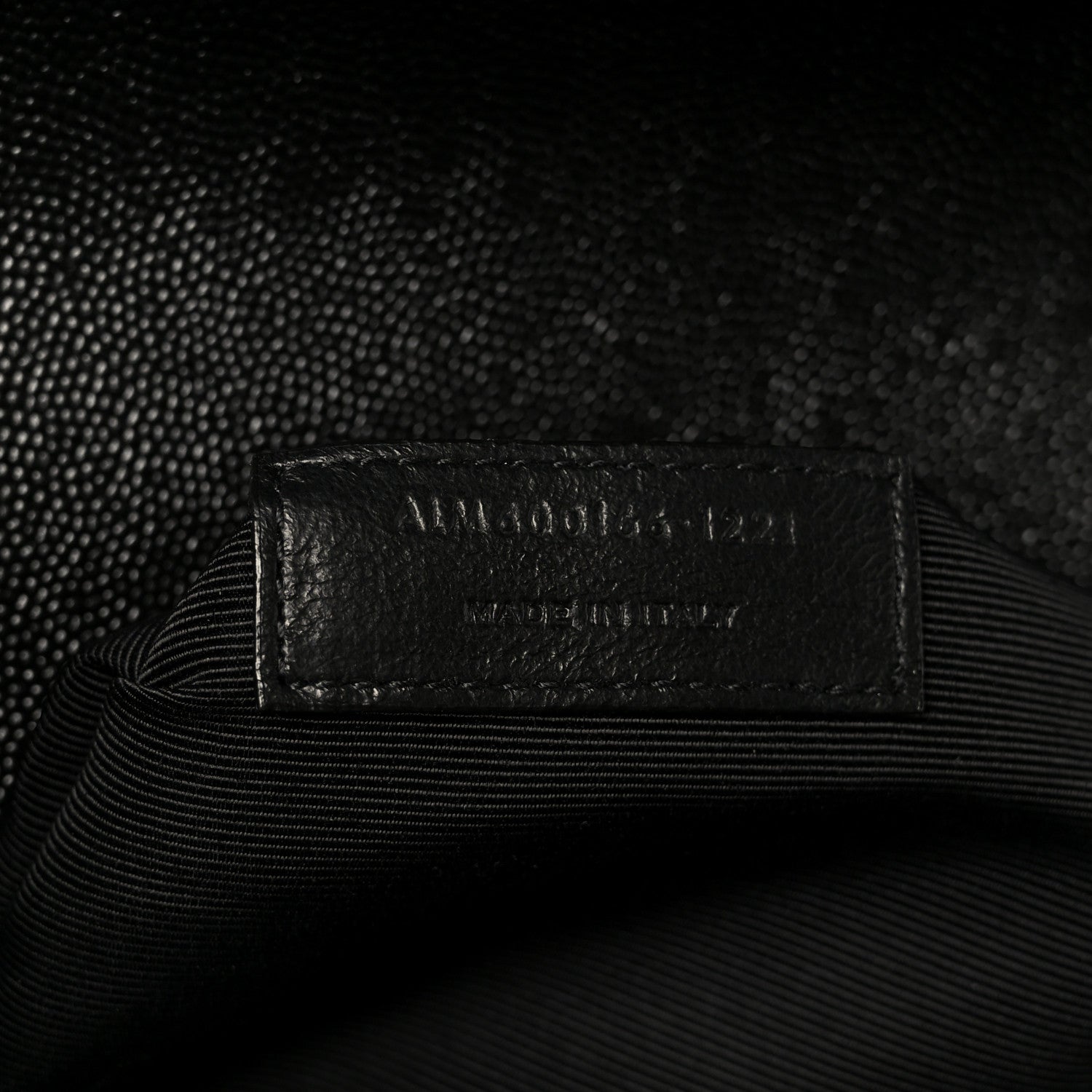 Black interior tag label with embossed text on lining