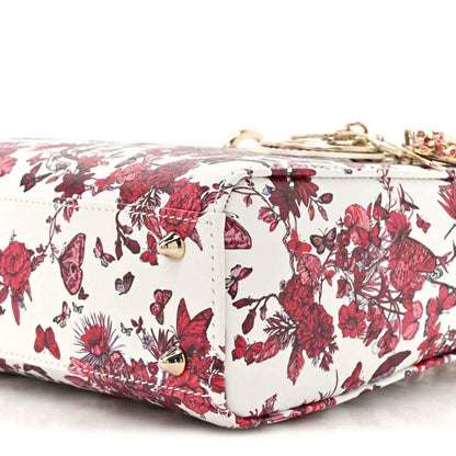 White and red floral handbag with top zipper and quilted side panels