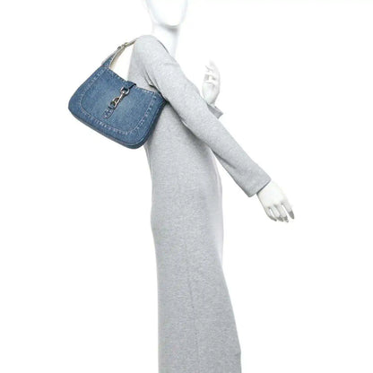 Blue denim small Jackie bag on a mannequin with a short detachable strap